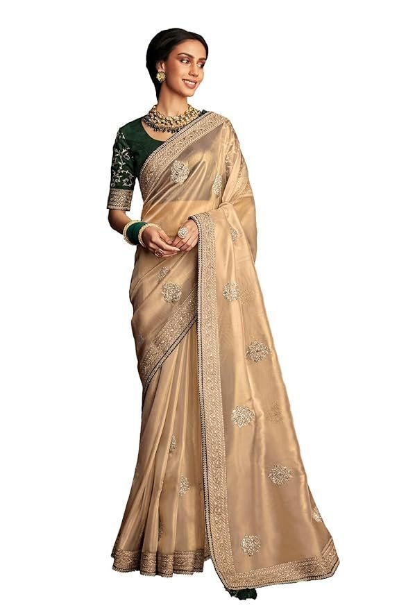 61oQVyQmHKL._SY879_.jpg Shimmer Net Gold-coloured saree featuring an all-over heavy gold zari butta and sequence work on body decorated with border with contrast navy blue piping - Image 1
